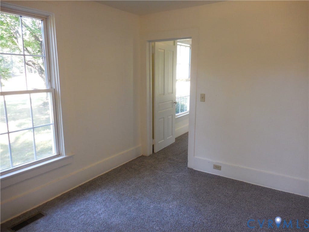 6507 Old Columbia Road, Columbia, Columbia, VA 23038 Neutral wall color, carpeted flooring, large window with grid panes, and white trim