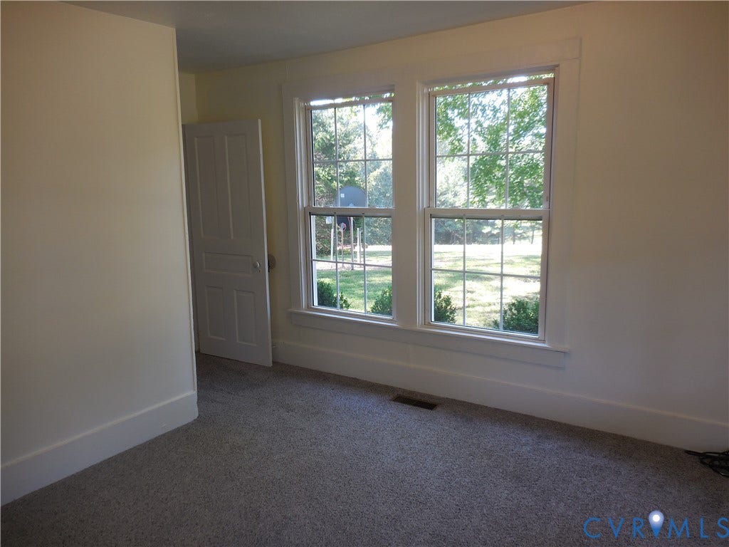 6507 Old Columbia Road, Columbia, Columbia, VA 23038 Dual windows with white trim, carpeting, and a white paneled door