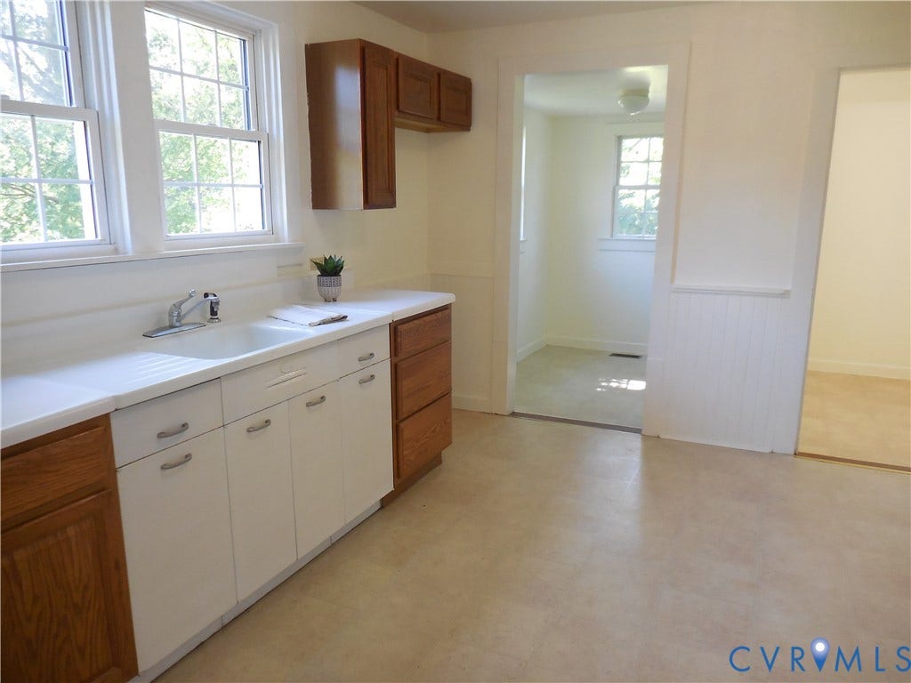 6507 Old Columbia Road, Columbia, Columbia, VA 23038 Kitchen featuring a double basin sink, white countertops, and wood cabinetry