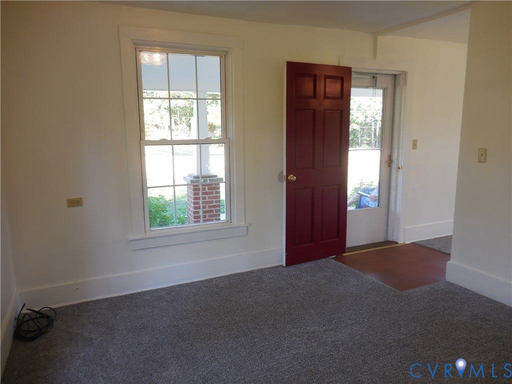6507 Old Columbia Road, Columbia, Columbia, VA 23038 Neutral wall color, carpeted flooring, white trim, and a paneled entry door