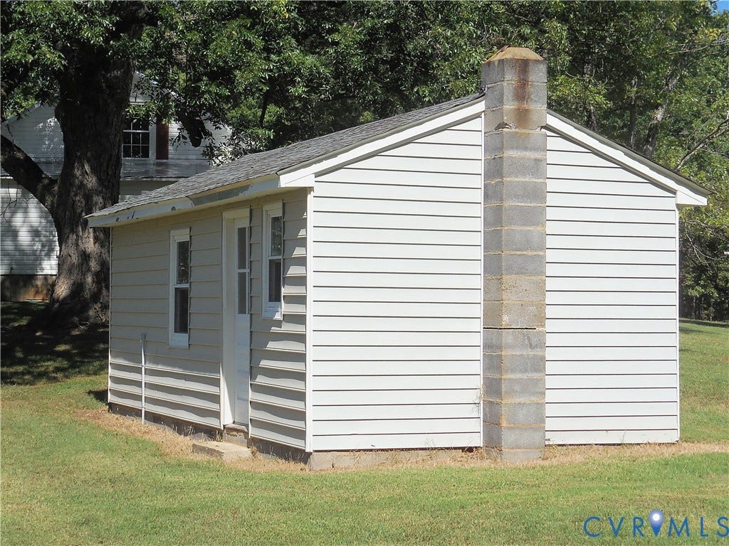6507 Old Columbia Road, Columbia, Columbia, VA 23038 Gabled structure with horizontal siding, a block chimney, and a single entry door