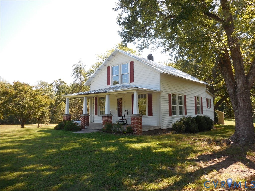 6507 Old Columbia Road, Columbia, Columbia, VA 23038 White siding exterior with a wraparound porch featuring brick pillars and white columns