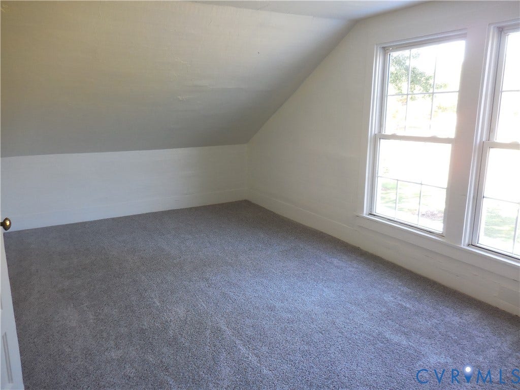 6507 Old Columbia Road, Columbia, Columbia, VA 23038 Room with angled ceilings, neutral-toned walls, gray carpeting, and two double-hung windows