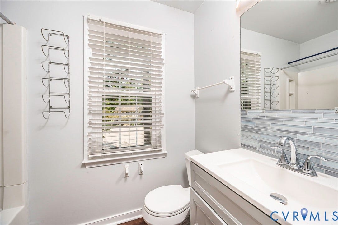 4605 English Cedar Court, Glen Allen, VA 23060 White single vanity with integrated sink, chrome faucet, and mosaic tile backsplash