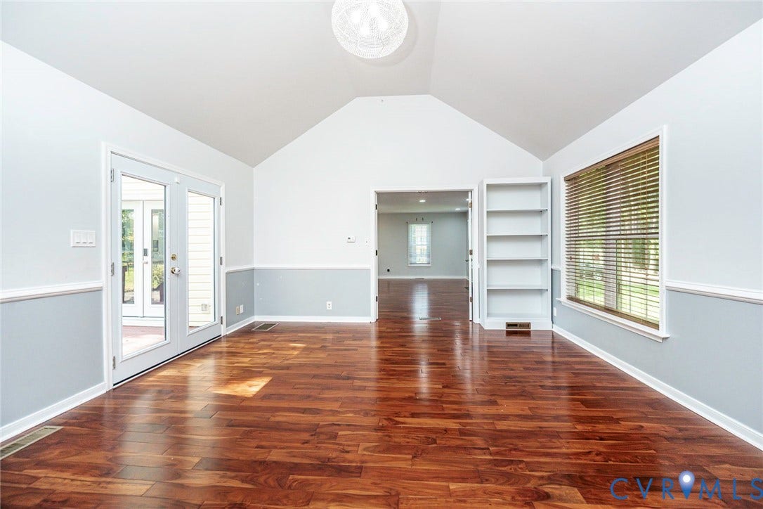4605 English Cedar Court, Glen Allen, VA 23060 Vaulted ceiling, wood-finish flooring, white double French doors, large window with blinds, and built-in shelving