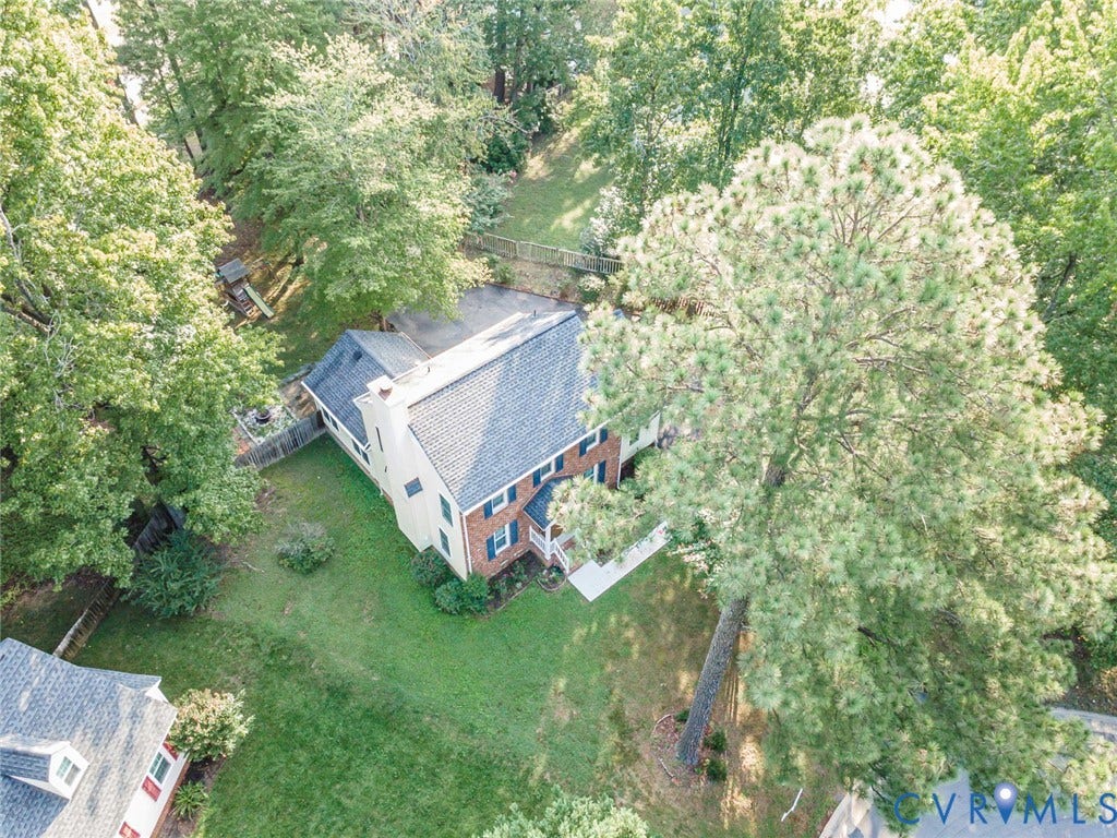 4605 English Cedar Court, Glen Allen, VA 23060 Brick and siding exterior featuring a multi-level roofline, prominent chimney, and a landscaped front yard with mature trees