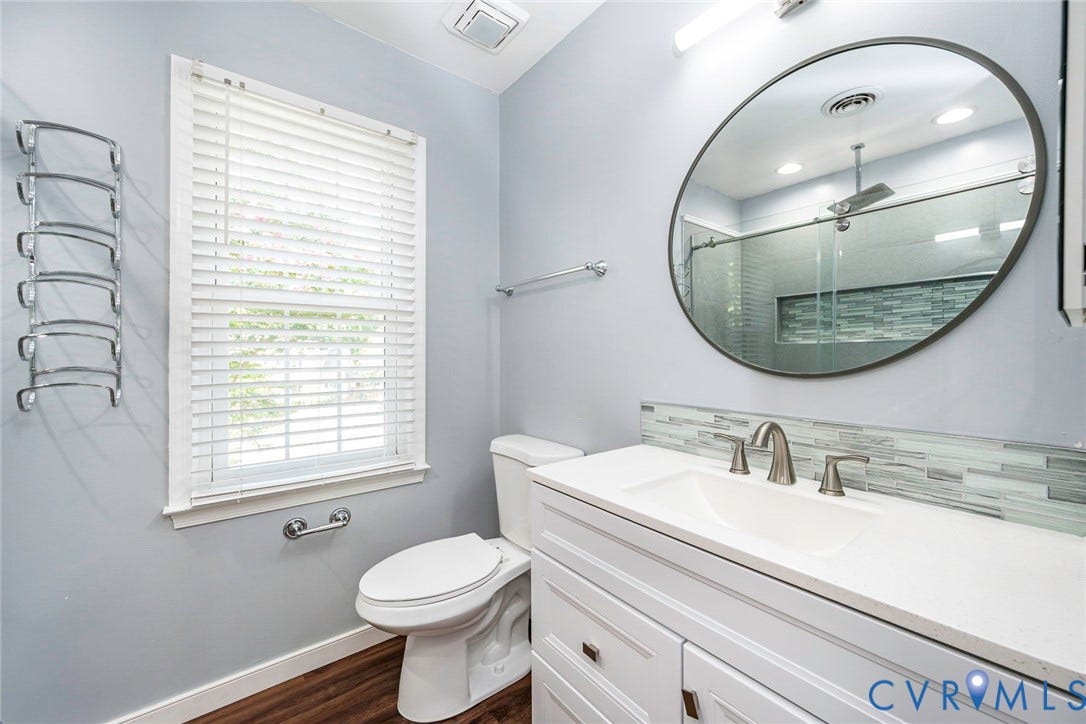 4605 English Cedar Court, Glen Allen, VA 23060 White vanity with a single basin, a tiled backsplash, and brushed nickel fixtures