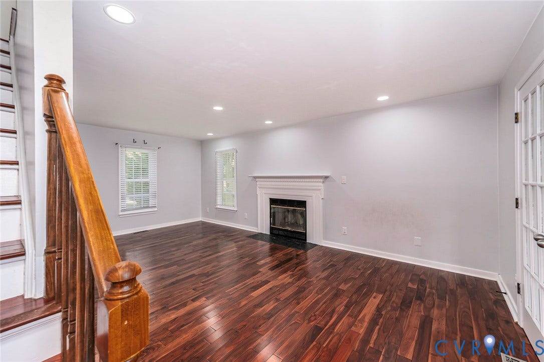 4605 English Cedar Court, Glen Allen, VA 23060 Spacious living area featuring wood-finish flooring, a fireplace with a white mantel, recessed lighting, and a French door
