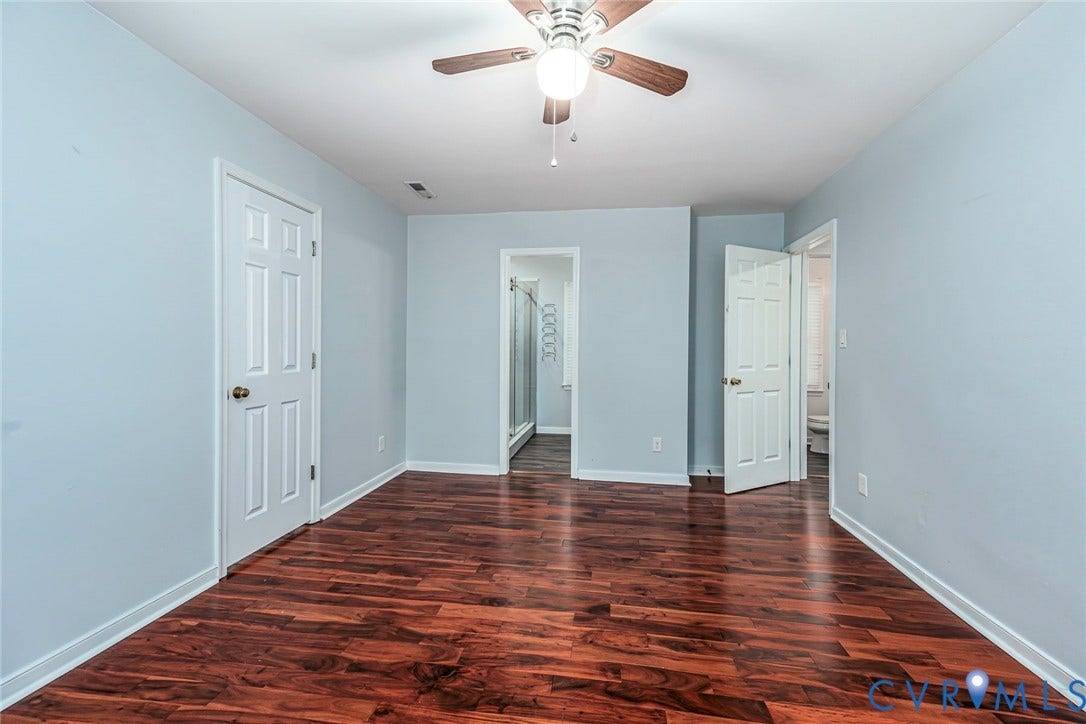 4605 English Cedar Court, Glen Allen, VA 23060 Wood-finish flooring, light blue wall paint, white trim, white paneled doors, and a ceiling fan with light fixture