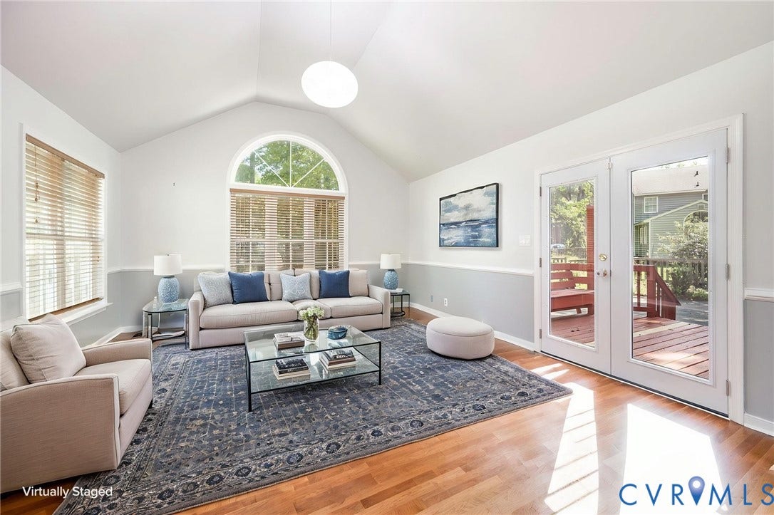 4605 English Cedar Court, Glen Allen, VA 23060 Vaulted ceiling with an arched window, wood-finish flooring, and double glass-paneled doors opening to an exterior deck