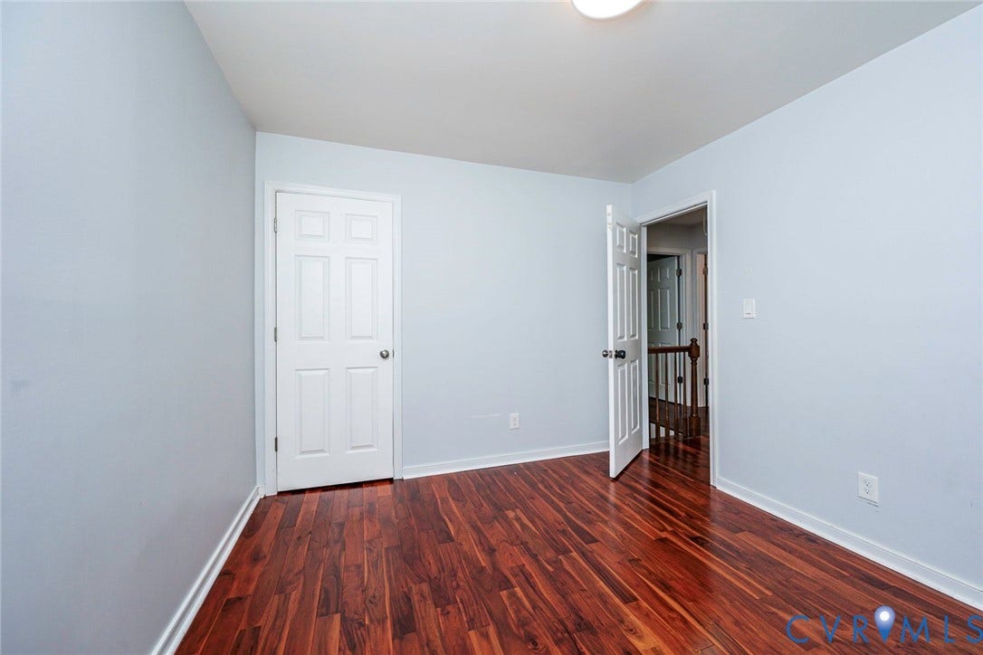 4605 English Cedar Court, Glen Allen, VA 23060 Wood-finish flooring, light blue wall paint, white trim throughout, and white paneled doors