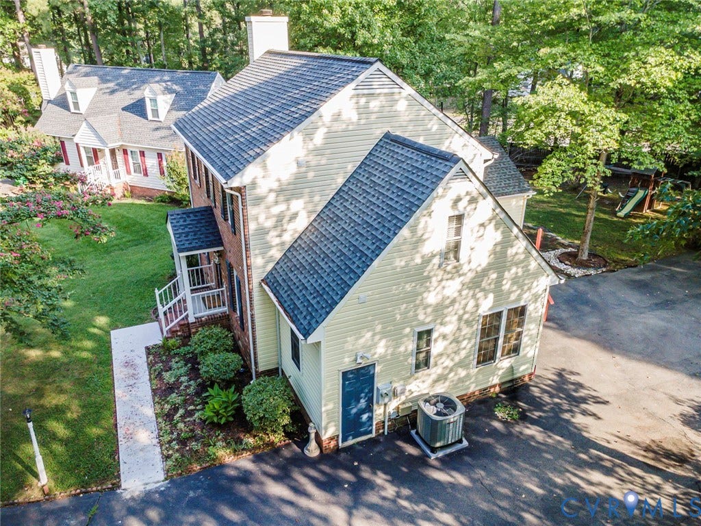 4605 English Cedar Court, Glen Allen, VA 23060 Expansive property featuring a multi-level structure, a dark shingle roof, established landscaping, and an asphalt driveway