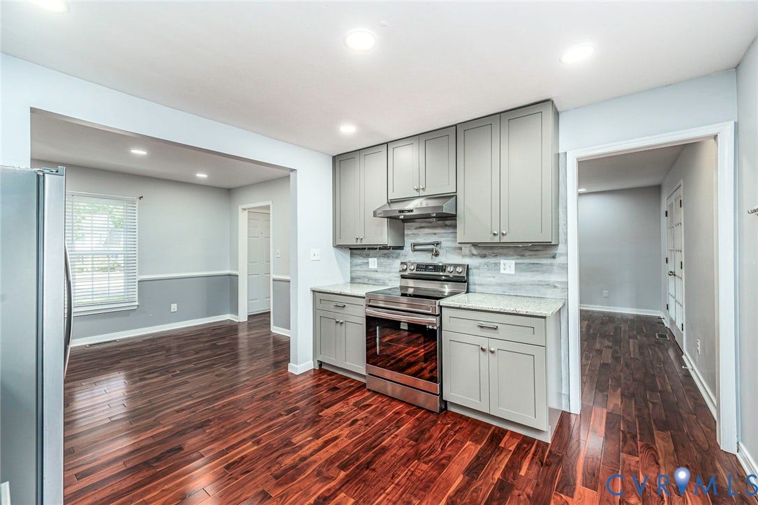 4605 English Cedar Court, Glen Allen, VA 23060 Wood-finish flooring throughout, stainless steel range with overhead ventilation, light-grey cabinetry with contemporary hardware, light-toned backsplash, and recessed lighting