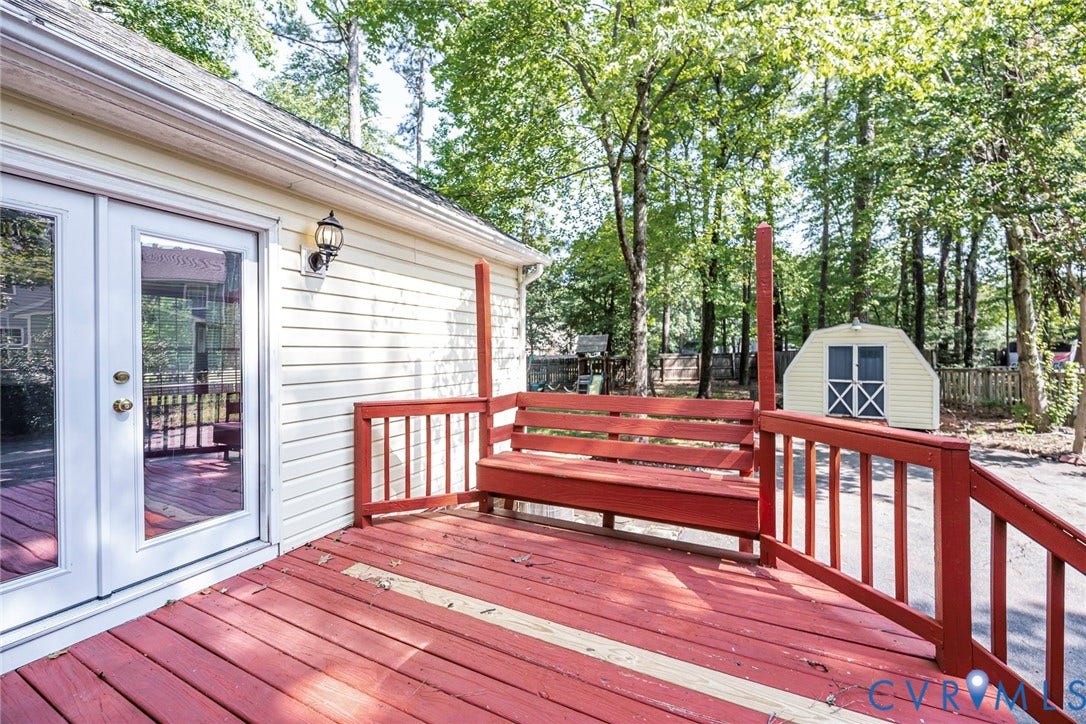 4605 English Cedar Court, Glen Allen, VA 23060 Spacious exterior deck with built-in bench seating, wood railing, and a detached storage shed