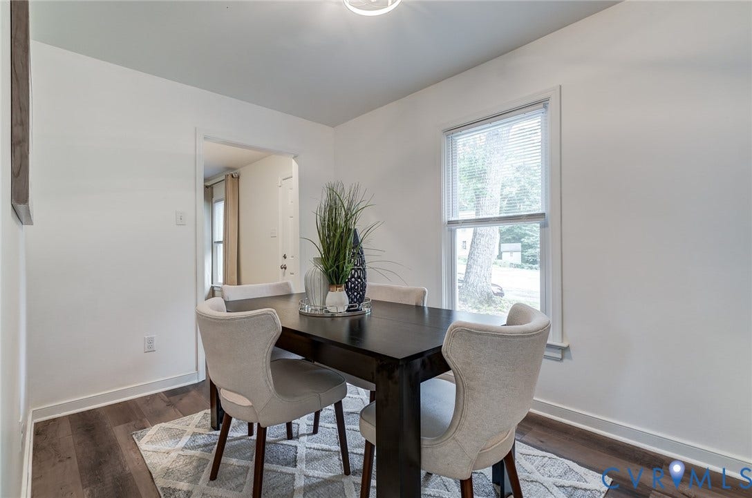 14 Redbridge Terrace, Shendoah Hills, Chesterfield, VA 23236 Bright dining room with wide-plank hardwood-look flooring and a large window for natural light.