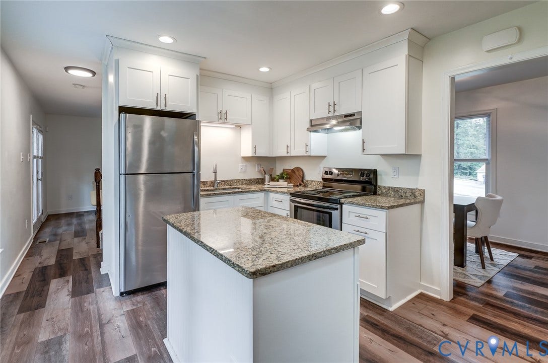 14 Redbridge Terrace, Shendoah Hills, Chesterfield, VA 23236 Bright, updated kitchen with white shaker cabinetry, granite countertops, stainless steel appliances and a center island.
