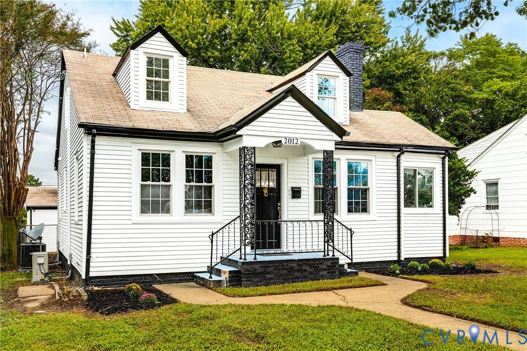 2012 Bailey Avenue, Richmond, VA 23231 White siding exterior with black trim, a gabled roof, and two dormer windows