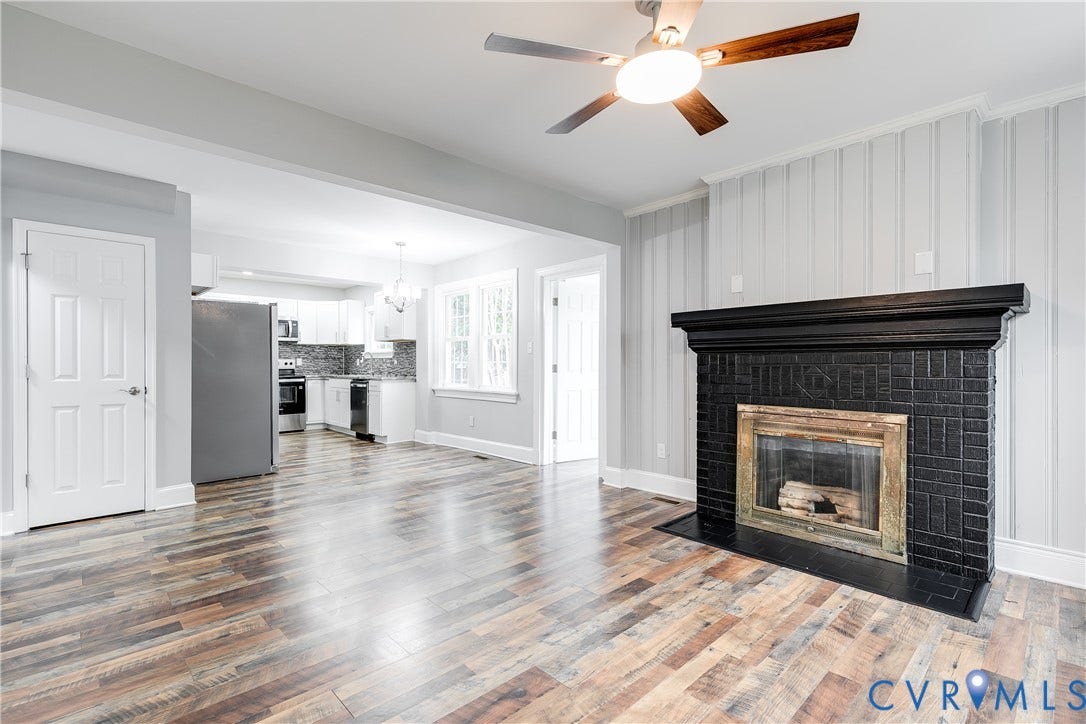 2012 Bailey Avenue, Richmond, VA 23231 Wood-finish flooring throughout, a black brick fireplace, and a ceiling fan with integrated lighting