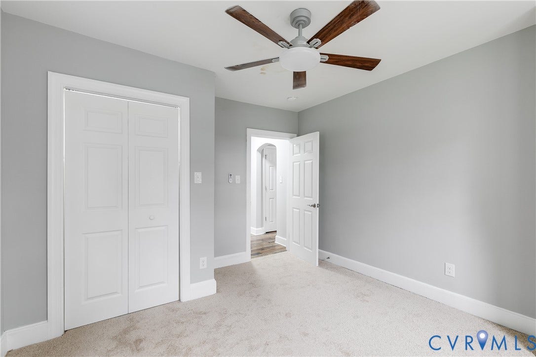 2012 Bailey Avenue, Richmond, VA 23231 Light gray wall color, neutral carpet flooring, white trim, ceiling fan with wood-finish blades, and a paneled bifold closet door