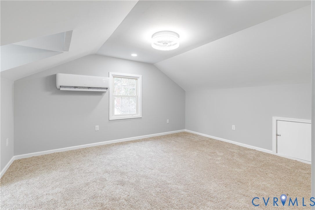 2012 Bailey Avenue, Richmond, VA 23231 Carpeted room with sloped ceilings, a window, built-in air conditioning unit, and a flush-mount ceiling light