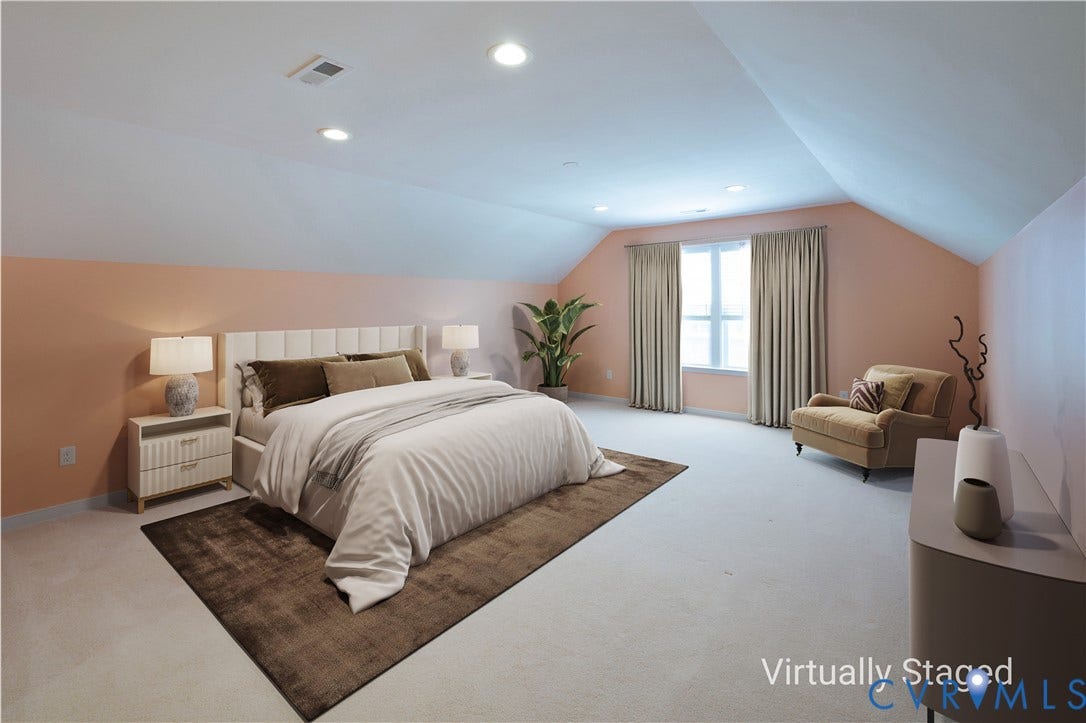 Vaulted ceilings with recessed lighting, light carpeting, and a window with natural light