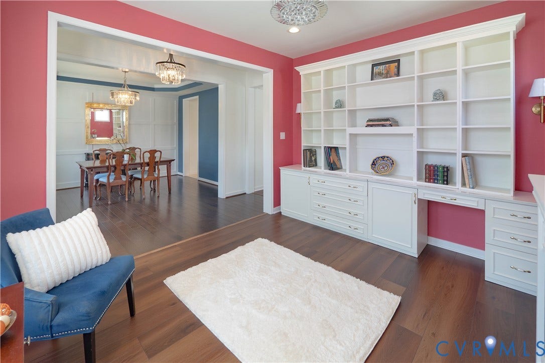 Wood-finish flooring throughout, with a built-in wall unit featuring shelving and cabinetry