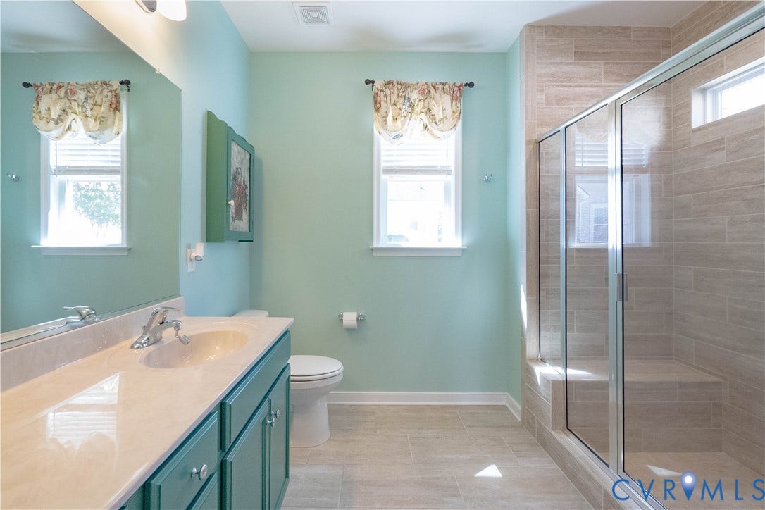 Vanity with an integrated sink, polished chrome faucet, and storage cabinetry