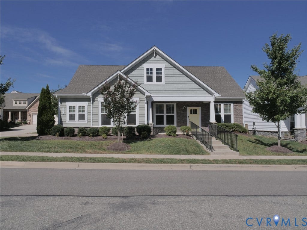 Gabled roofline with shingle siding and brick accents