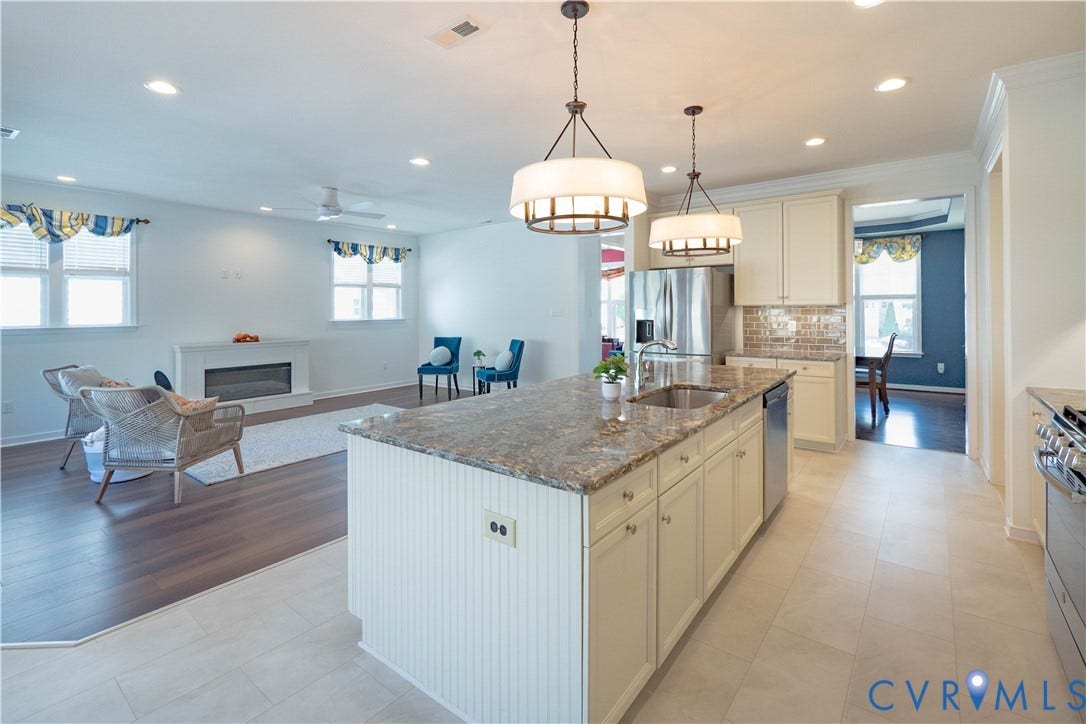 Kitchen island featuring a dual-basin sink and integrated dishwasher