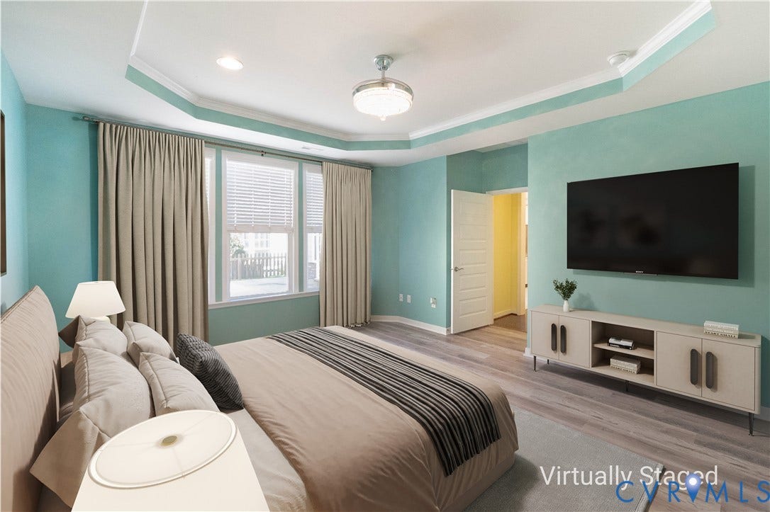 Tray ceiling with crown molding, recessed lighting, ceiling fan, multiple windows with blinds, and wood-finish flooring