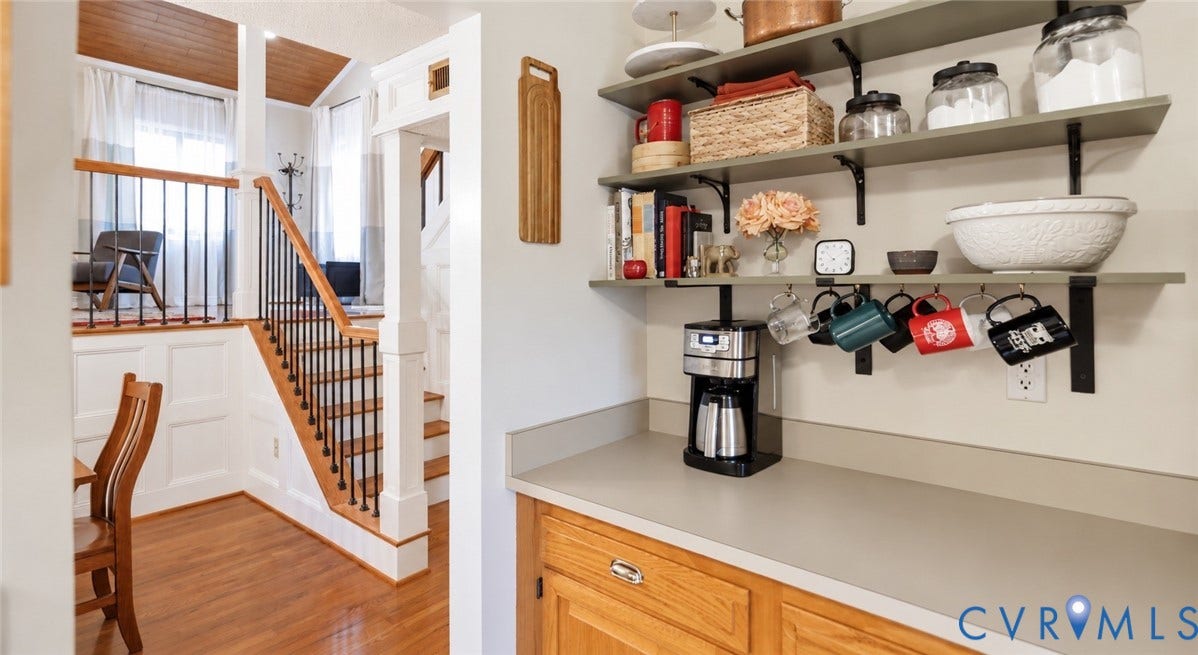 2203 Rockwater Terrace, Henrico, VA 23238 Hardwood flooring, white wainscoting, and a staircase with black iron balusters