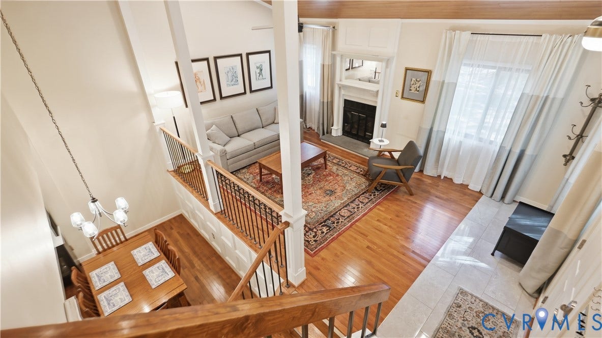 2203 Rockwater Terrace, Henrico, VA 23238 Vaulted ceilings, wood-finish flooring, staircase with wood handrails and wrought iron balusters, fireplace with mantel, and tile flooring