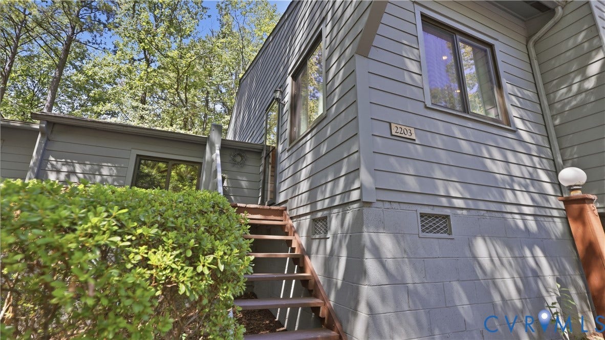 2203 Rockwater Terrace, Henrico, VA 23238 Exterior featuring horizontal siding, multi-pane windows, and a prominent entry staircase