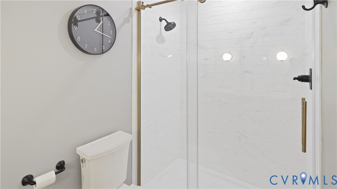2203 Rockwater Terrace, Henrico, VA 23238 Glass-enclosed shower with a rainfall showerhead and matte black fixtures