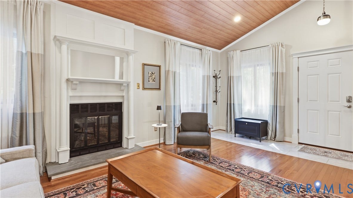 2203 Rockwater Terrace, Henrico, VA 23238 Vaulted wood-paneled ceiling, white paneled door, stone fireplace surround, white fireplace mantel, and wood-finish flooring