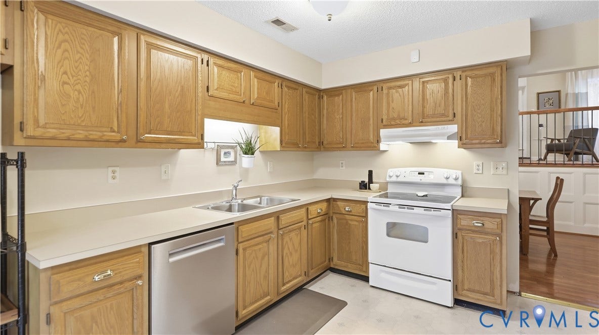 2203 Rockwater Terrace, Henrico, VA 23238 Kitchen featuring wood cabinetry, white countertops, stainless steel dishwasher, and white appliances