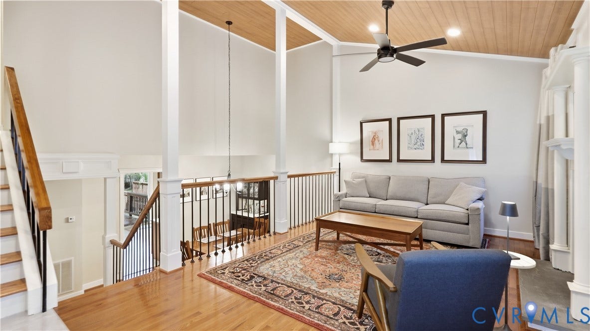 2203 Rockwater Terrace, Henrico, VA 23238 Hardwood flooring, vaulted wood-paneled ceiling, white painted columns, iron balusters, and a ceiling fan
