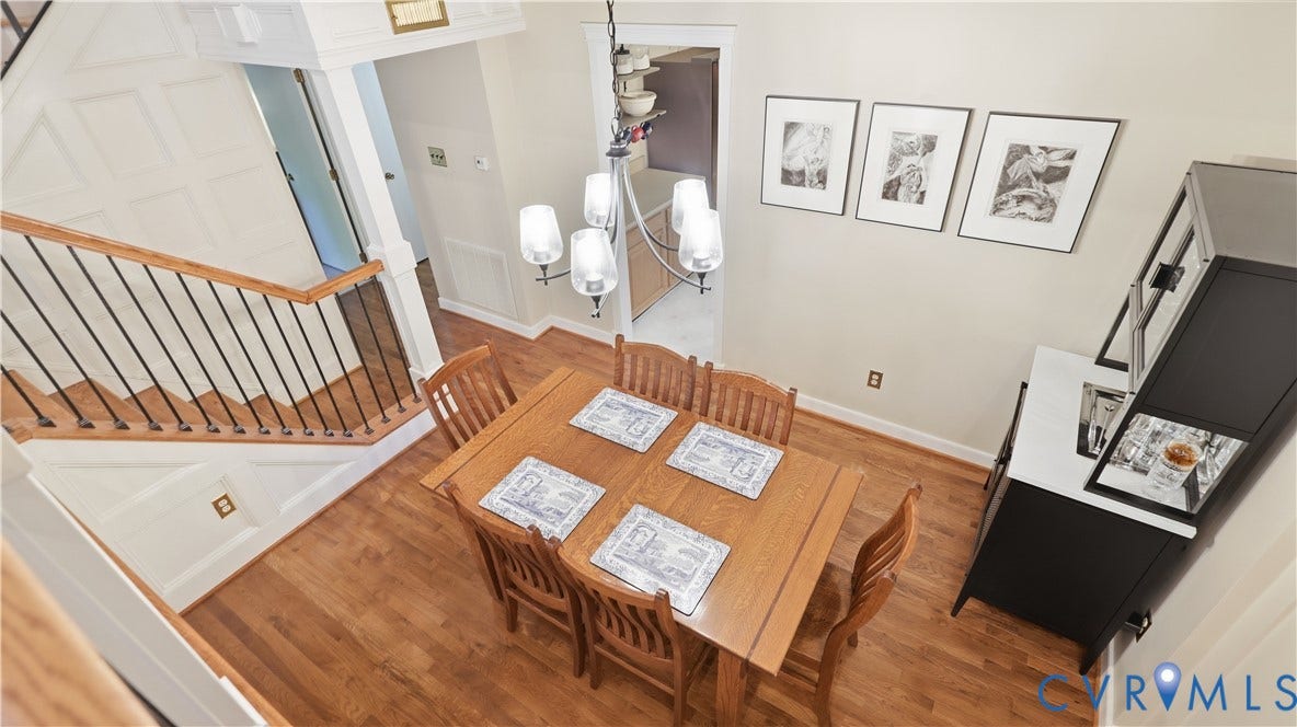 2203 Rockwater Terrace, Henrico, VA 23238 Hardwood flooring throughout, with a white paneled staircase featuring black metal balusters