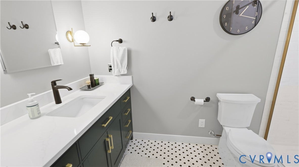 2203 Rockwater Terrace, Henrico, VA 23238 White single-basin vanity with a dark finish cabinet and gold-tone hardware