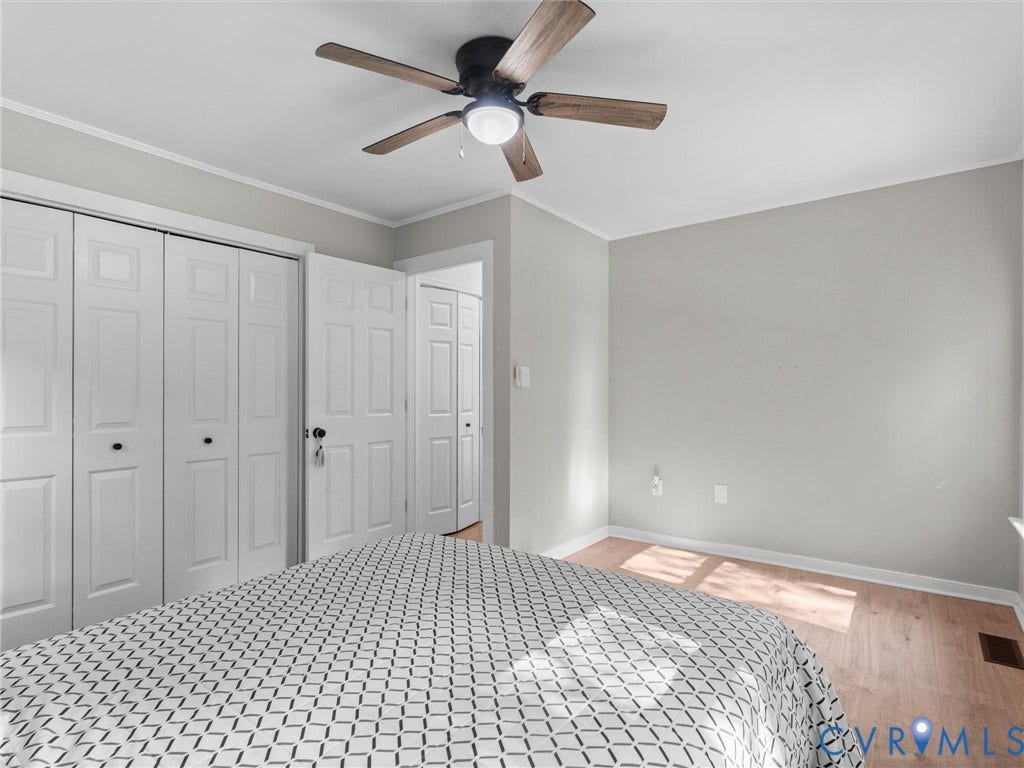 Recessed ceiling fan with light fixture, light wood-finish flooring, white bifold closet doors, painted walls, and white trim