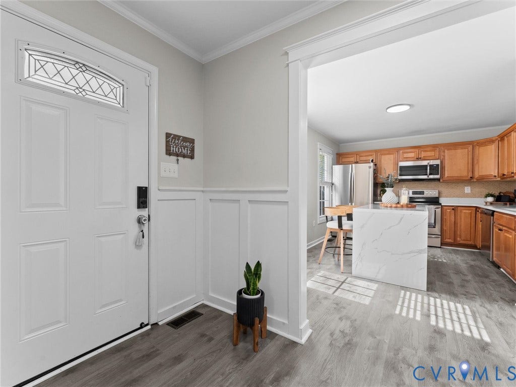Entryway featuring board and batten wall paneling and wood-finish flooring