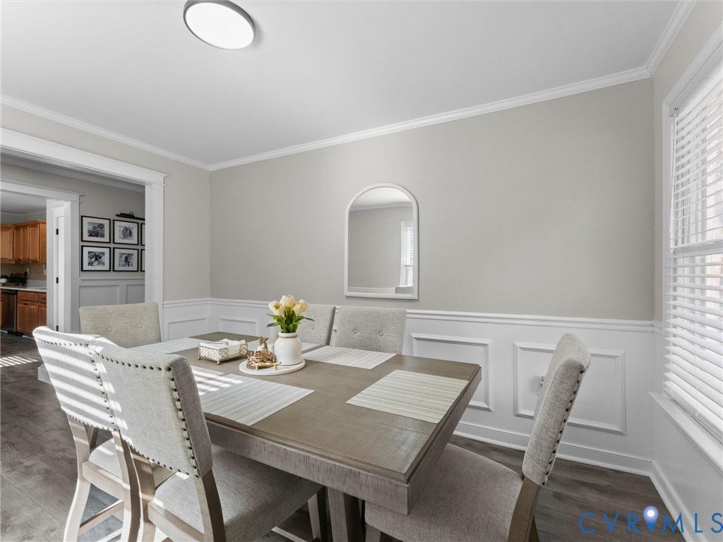 Recessed arch wall niche, picture frame wainscoting, and crown molding
