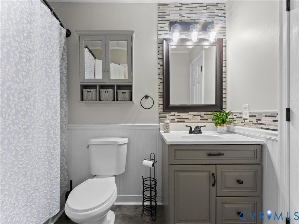 Vanity with gray cabinetry, white countertop, and integrated sink