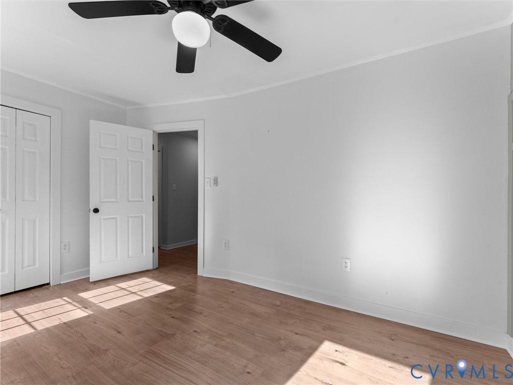 Wood-finish flooring with white walls and trim