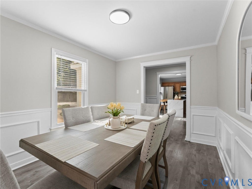 Wood-finish flooring, crown molding, chair rail molding, recessed window, and flush mount lighting