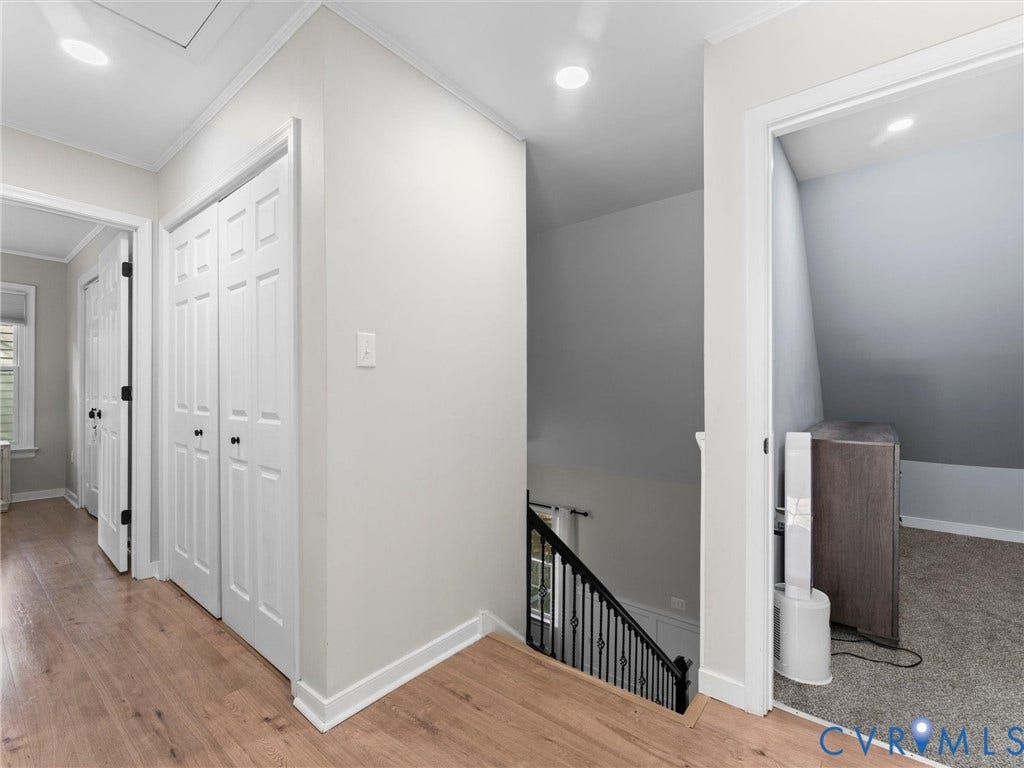 Light wood-finish flooring with white trim