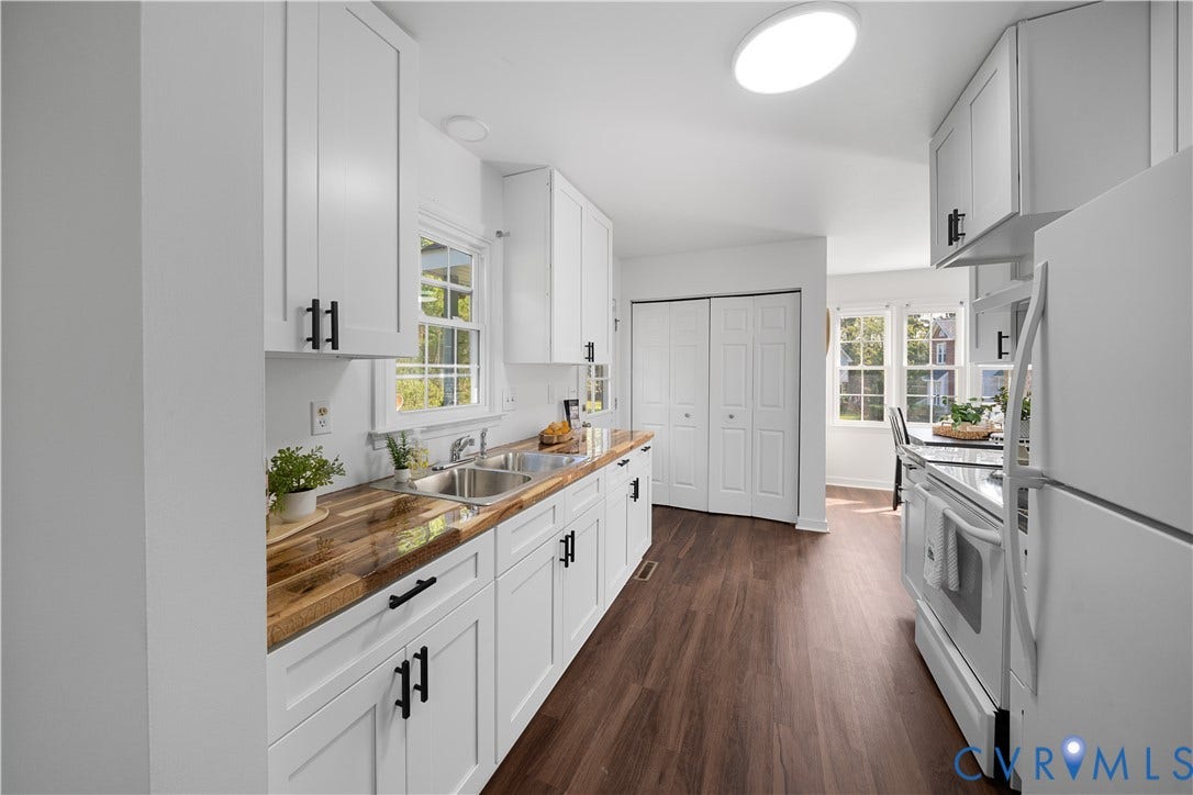 8414 Whirlaway Drive, Matoaca, Midlothian, VA 23112 Kitchen featuring white cabinetry with black hardware, wood-finish countertops, a double basin stainless steel sink, and wood-finish flooring