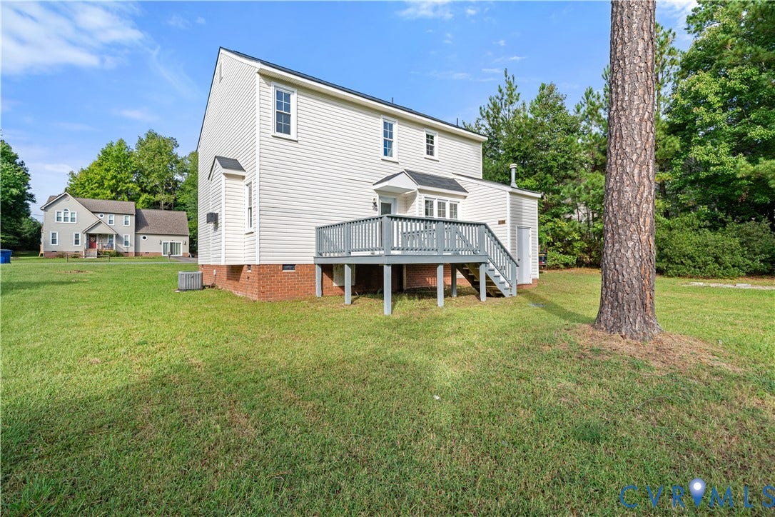 8414 Whirlaway Drive, Matoaca, Midlothian, VA 23112 Expansive grassy yard with mature trees, a multi-level wood deck, and horizontal siding exterior