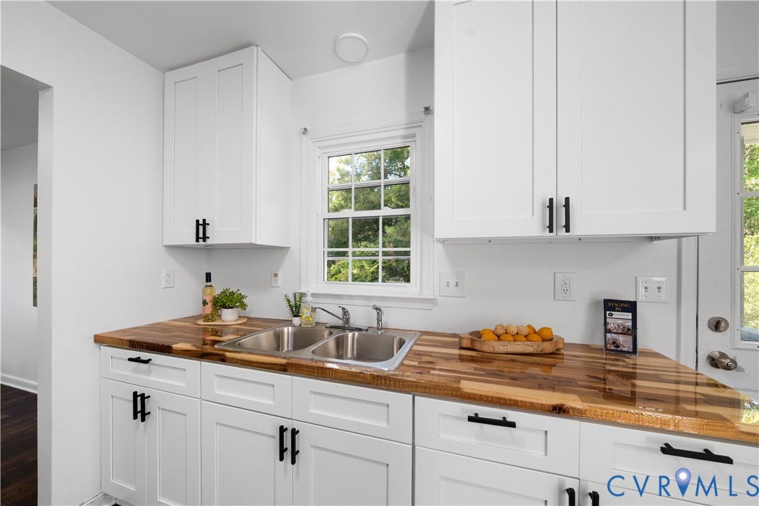 8414 Whirlaway Drive, Matoaca, Midlothian, VA 23112 White shaker-style cabinetry with matte black hardware, wood-finish countertops, and a dual stainless steel sink