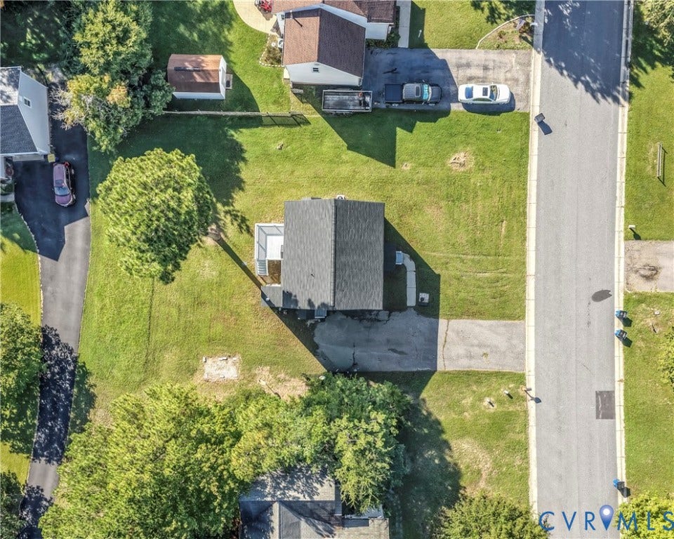 8414 Whirlaway Drive, Matoaca, Midlothian, VA 23112 Gable roof, expansive green space, paved driveway, adjacent residential structures, and mature trees